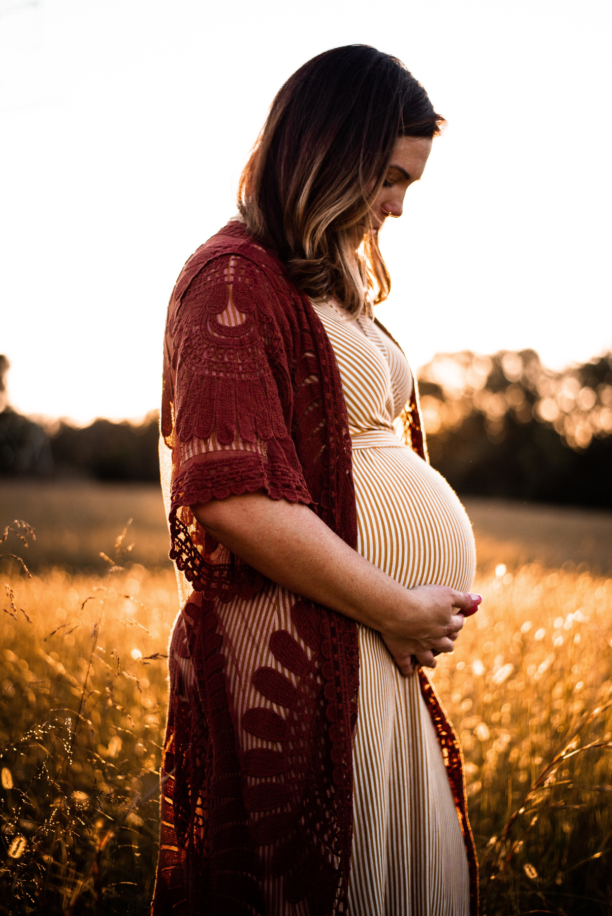 Pregnant woman holding belly in wheat field.

Midwife Kaleigh honors natural birth in out of hospital settings. 